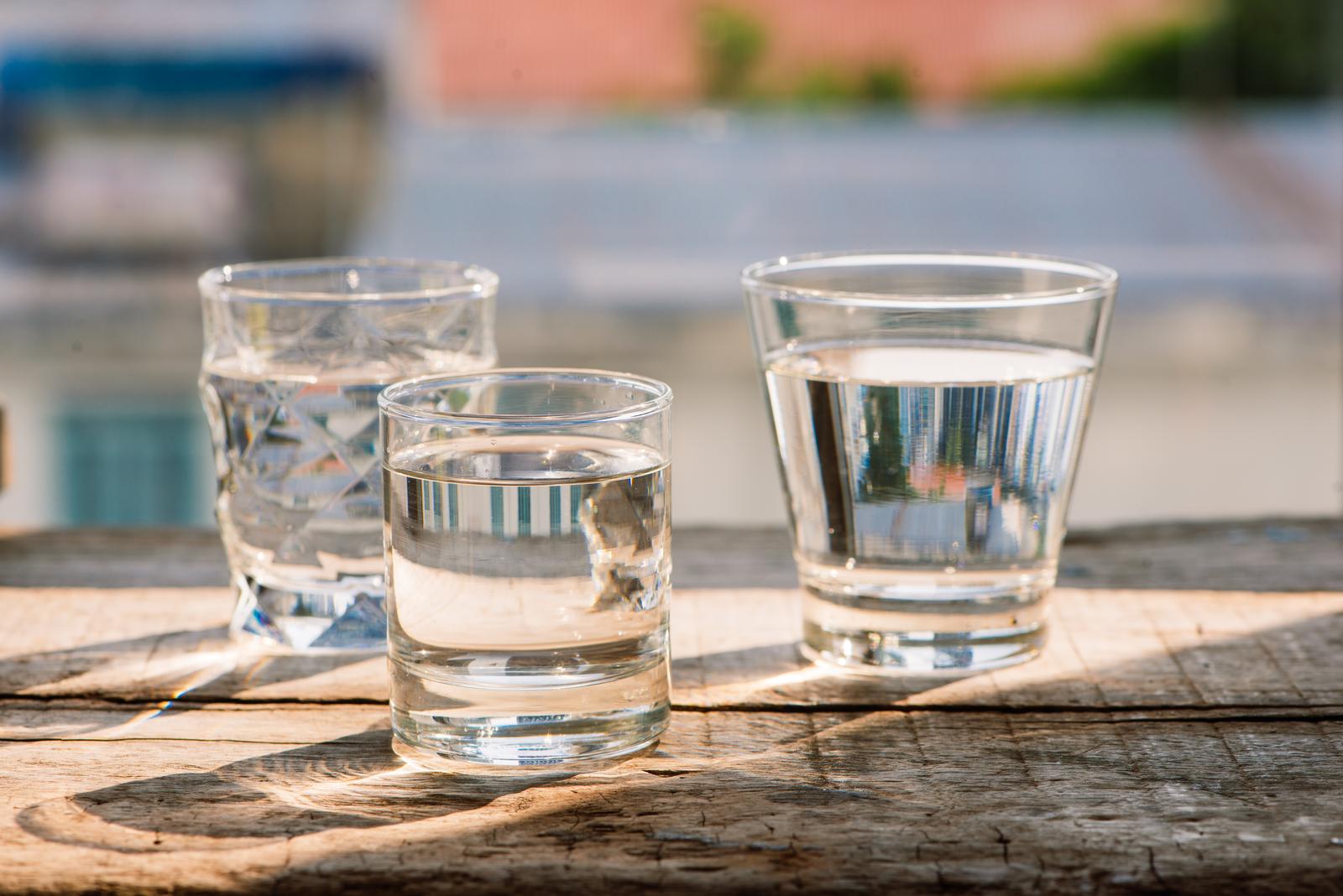 Drink a glass of water on a wooden floor.
