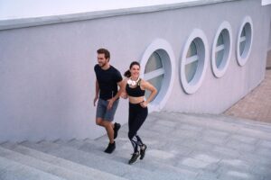 Runner athletes running on stairs. Couple fitness is jogging oudoors