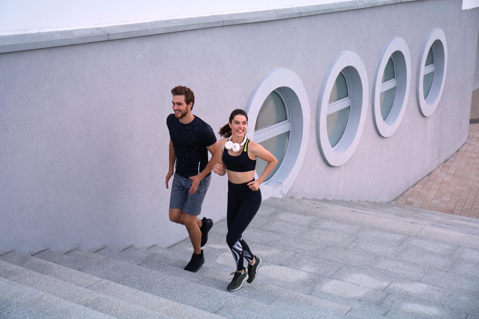 Runner athletes running on stairs. Couple fitness is jogging oudoors